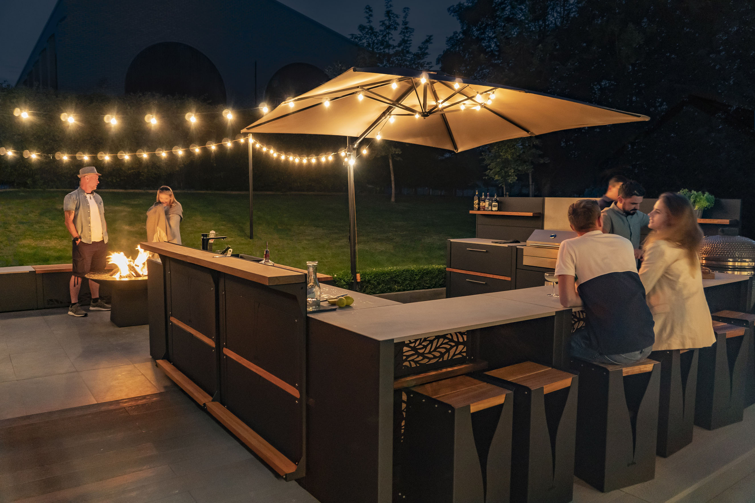 Grillo outdoor kitchen at dusk with ambient lighting and seating